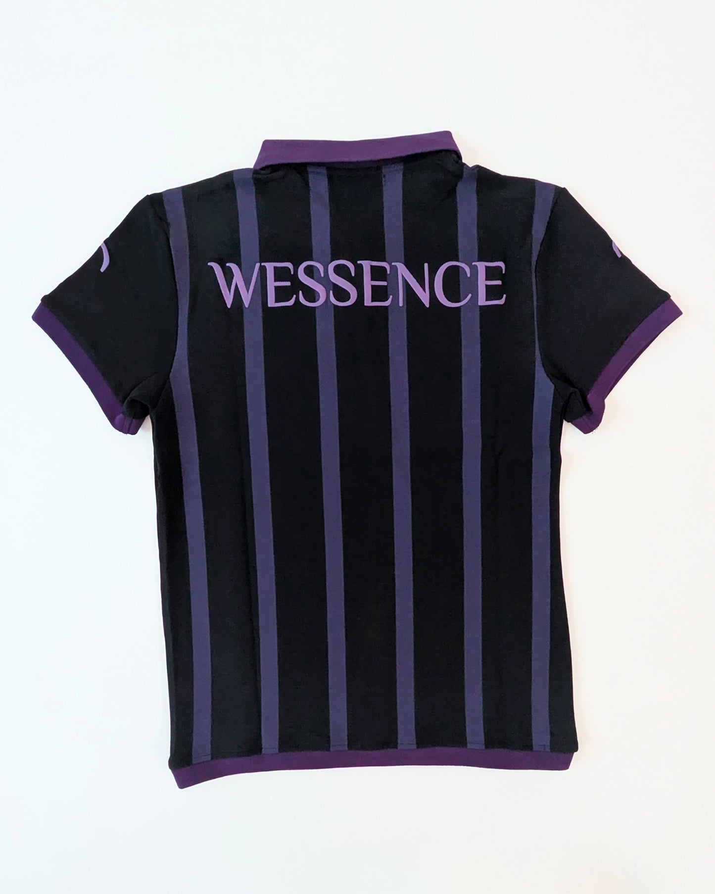 Back view WESSENCE ENIGMA black and purple striped polo shirt, neck logo detail, urban chic style.